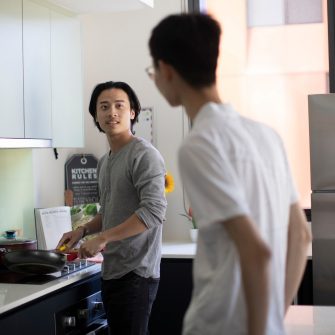 Students cooking in kitchen of student accommodation